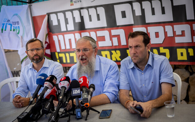 Gush Eztion Regional Council head Shlomo Ne'eman (center) speaks during a press conference with Samaria Regional Council head Yossi Dagan (right) and Binyamin Regional Council head Yisrael Gantz, outside the Prime Minister's Office in Jerusalem, August 22, 2023. (Yonatan Sindel/Flash90)