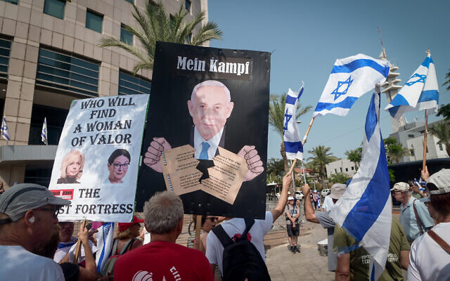 Protesters against the government's judicial overhaul, including one with a sign portraying Prime Minister Benjamin Netanyahu under the words "Mein Kampf, rally in Tel Aviv on August 31, 2023. (Avshalom Sassoni/Flash90)