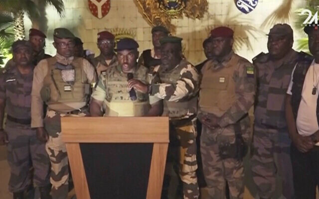 This video grab shows the spokesperson for the mutinous soldiers speaking on state television as they announce that they had seized power in Libreville, August 30, 2023. (GABON 24 via AP)