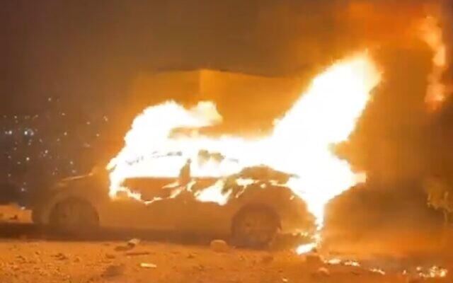 A car belonging to an Israeli who mistakenly entered the Palestinian West Bank town of Turmus Ayya goes up in flames on August 20, 2023. (Screenshot: Twitter; used in accordance with Clause 27a of the Copyright Law)