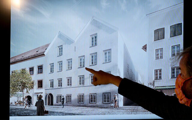 A man points his finger at a screen showing the chosen plan for the architectural redesign of Adolf Hitler's birth house, during a press conference at the Interior ministry in Vienna, Austria on June 2, 2020. (Joe Klamar/AFP)