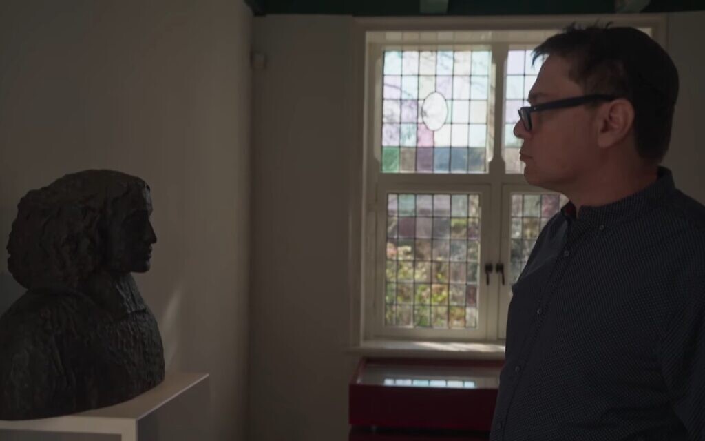 Yitzhak Melamed looks at a bust of Spinoza in a screenshot from the film, 'Spinoza: 6 Reasons for the Excommunication of the Philosopher.' (Used in accordance with Clause 27a of the Copyright Law)