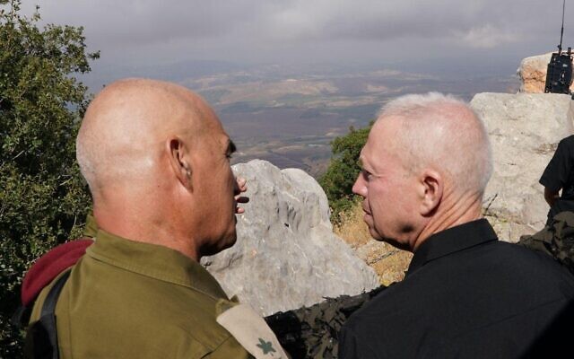 Defense Minister Yoav Gallant (right) and head of the IDF Northern Command, Maj. Gen. Ori Gordin, look toward Lebanon from the Mount Dov area, August 8, 2023. (Ariel Hermoni/Defense Ministry)