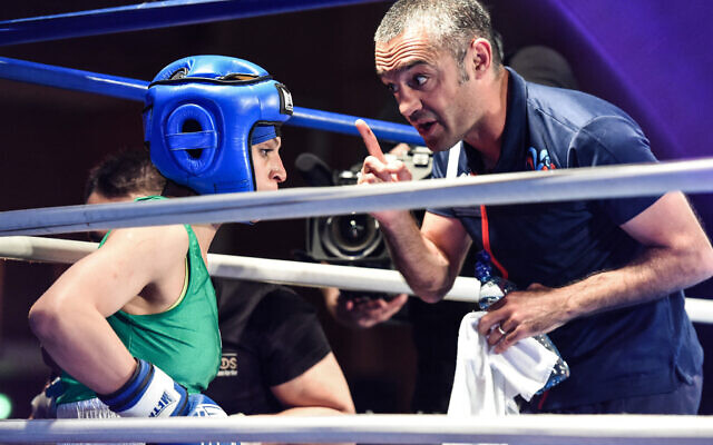 Iranian boxer Sadaf Khadem (L) is coached by combat organizer Mahyar Monshipour (R), an Iranian-born former super bantamweight world champion, during a match in Royan, western France, on April 13, 2019. Khadem now resides in France (MEHDI FEDOUACH / AFP / File)