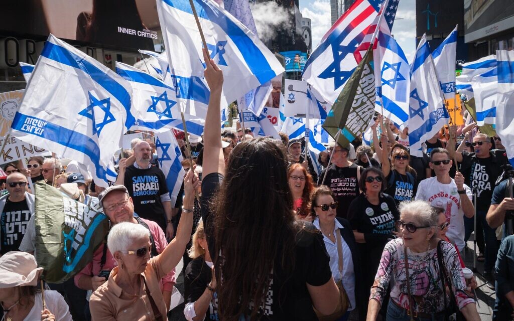 Israelis protest the judicial overhaul in New York City's Times Square as Prime Minister Benjamin Netanyahu visits the city to meet with world leaders at the UN's General Assembly, September 19, 2023. (Luke Tress/Times of Israel)