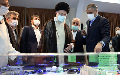 A handout picture made available by the office of Iran's Supreme Leader Ayatollah Ali Khamenei shows him (C) visiting an exhibition of the country's nuclear industry achievements in Tehran, on June 11, 2023, accompanied by the head of the Atomic Energy Organization of Iran Mohammad Eslami (R) (KHAMENEI.IR / AFP)