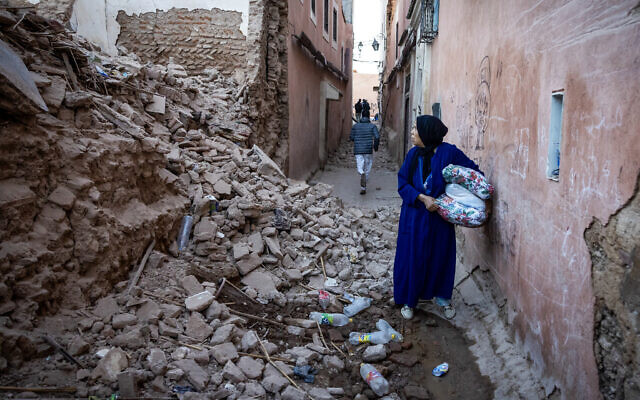 A woman looks at the rubble of a building in the earthquake-damaged old city in Marrakesh, Morocco, on September 9, 2023. (Fadel Senna/AFP)