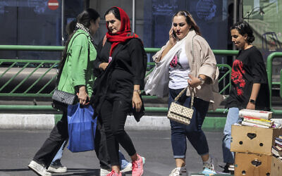 Women walk along Enghelab Square in central Tehran on September 10, 2023. (Atta Kenare/AFP)