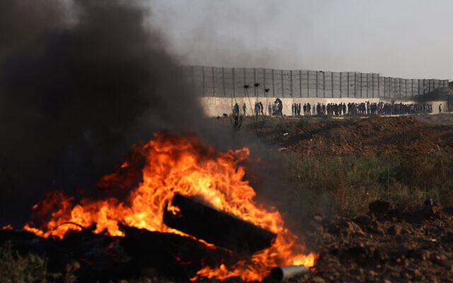 Tires burn as Palestinian rioters clash with Israeli soldiers along the Israel-Gaza border on September 15, 2023. (Mohammed Abed/AFP)