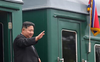 North Korea's leader Kim Jong Un waves before boarding a train during a farewell ceremony at the end of his visit to Russia at the Artyom railway station near Vladivostok, in the Primorsky region, on September 17, 2023. (Handout / Government of Primorsky region / AFP)