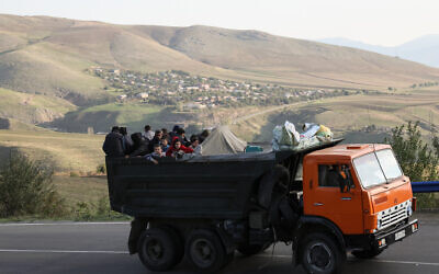 A truck with refugees on board rides on the road between Kornidzor and Goris on September 28, 2023. Armenia on September 26, 2023, said 28,120 refugees have so far arrived from Nagorno-Karabakh, a majority ethnic Armenian breakaway enclave defeated in a lightning offensive by Azerbaijan last week. (ALAIN JOCARD / AFP)