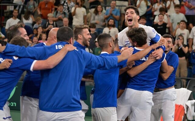 Israel's national tennis team celebrates after defeating Japan in the Davis Cup, September 17, 2023. (Israel Tennis Association)