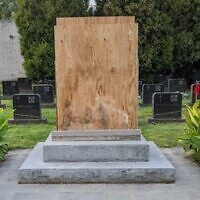 A boarded-up memorial to a Ukrainian SS division in a Catholic cemetery in Elkins Park, Pennsylvania, Sept. 12, 2023. The local Ukrainian Catholic Archeparchy covered up the memorial after Jewish groups condemned it. (Courtesy of Lev Golinkin via JTA)