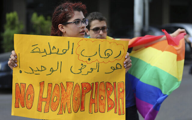 Supporters of the LGBT (Lesbian, Gay, Bisexual, and Transgender) community attend a sit-in to protest the ongoing criminalization of homosexuality and arbitrary arrests in front of Hobeich police station, in Beirut, Lebanon, Sunday, May 15, 2016. (AP/Hussein Malla)