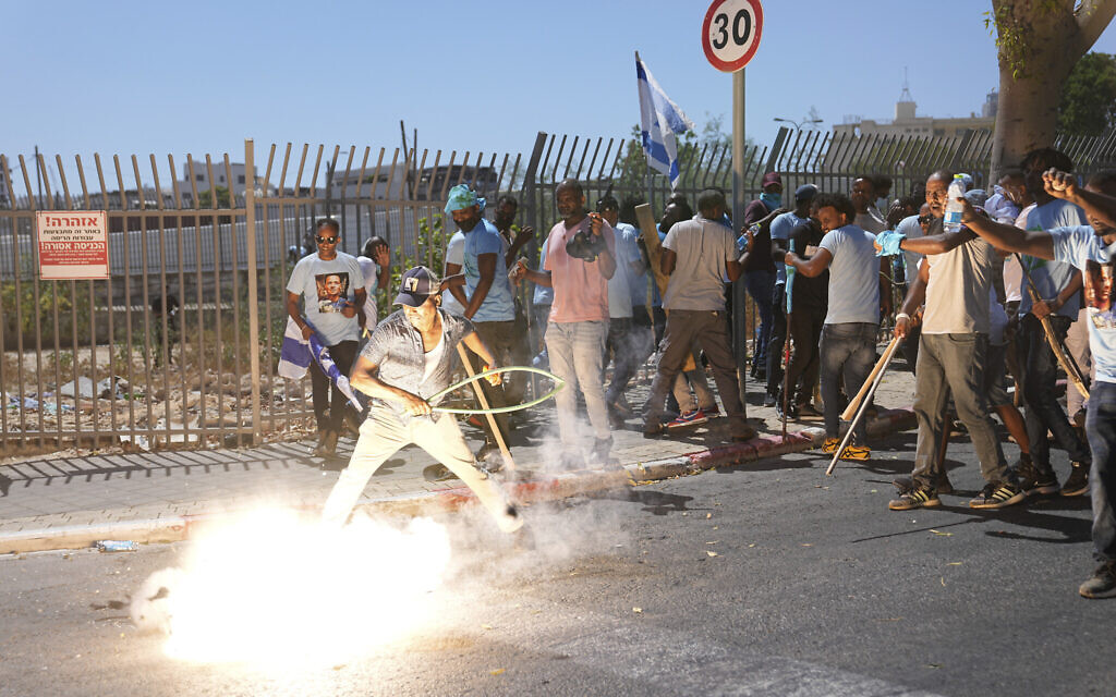 A stun grenade thrown by Israeli police explodes next to Eritrean protesters during a protest against an event organized by the Eritrea Embassy, in Tel Aviv, Israel, Sept. 2, 2023 (AP Photo/Ohad Zwigenberg)