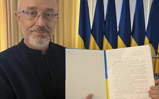In this photo provided by the Ukrainian Parliament Press Office, Ukrainian Minister of Defense Oleksii Reznikov shows his resignation letter addressed to the Parliamentary Speaker in Kyiv, Ukraine, Monday, Sept. 4, 2023. (Ukrainian Parliament Press Office via AP)