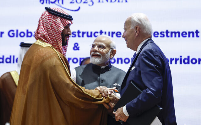 Saudi Arabian Crown Prince Mohammed bin Salman Al Saud, left, and US President Joe Biden, right, shake hands next to Indian Prime Minister Narendra Modi at the G20 summit in New Delhi, India, September 9, 2023. (AP Photo/Evelyn Hockstein, Pool)