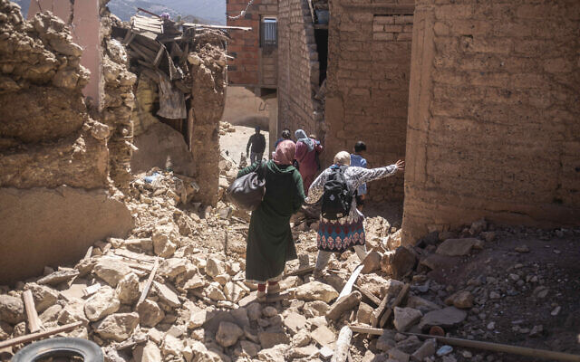 Residents flee their homes after an earthquake in Moulay Brahim village, near the epicenter of the earthquake, outside Marrakech, Morocco, September 9, 2023. (AP Photo/Mosa'ab Elshamy)