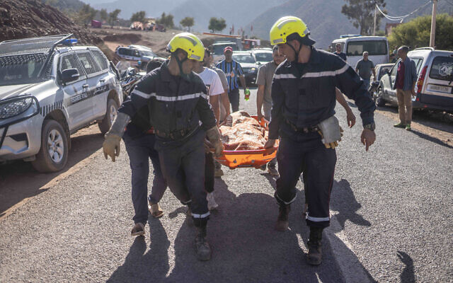 Members of rescue teams carry the body of a victim of an earthquake in Ouargane village, near Marrakech, Morocco, September 9, 2023. (Mosa'ab Elshamy/AP)