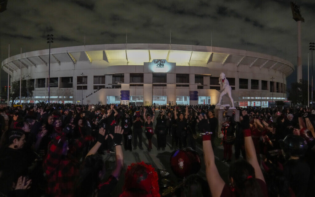 Musicians and dancers perform in front of the National Stadium, which served as a detention center in the early years of the military dictatorship, during a vigil marking the 50th anniversary of the 1973 military coup that toppled the government of late President Salvador Allende, in Santiago, Chile, September 11, 2023. (AP Photo/Esteban Felix)