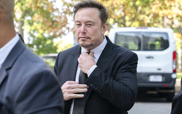 Elon Musk, CEO of X, the company formerly known as Twitter, tightens his tie as he arrives for a closed-door gathering of leading tech CEOs to discuss the priorities and risks surrounding artificial intelligence and how it should be regulated, at Capitol Hill in Washington, September 13, 2023.(Jacquelyn Martin/AP)