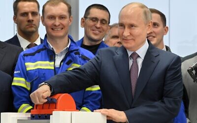 Russian President Vladimir Putin, foreground right, attends the launch ceremony for the first technological line for liquefying natural gas on gravity bases as part of the Arctic LNG2 project, in the village of Belokamenka, about 1,063 miles north of Moscow, Murmansk region, Russia, Thursday, July 20, 2023. (Alexander Kazakov, Sputnik, Kremlin Pool Photo via AP, File)