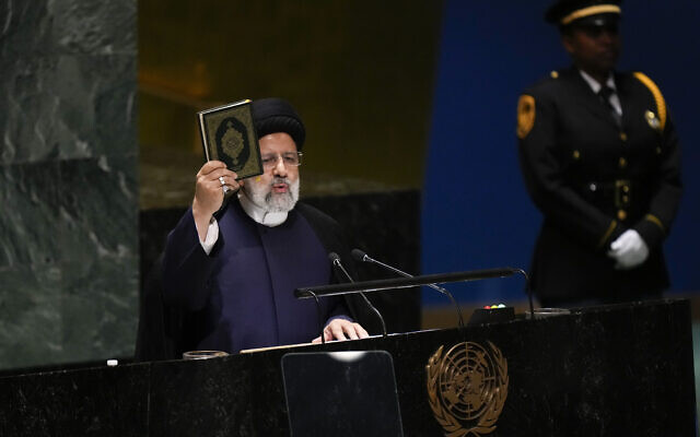 Iran’s President Ebrahim Raisi holds up a Quran as he addresses the 78th session of the United Nations General Assembly at United Nations headquarters, September 19, 2023. (AP Photo/Seth Wenig)