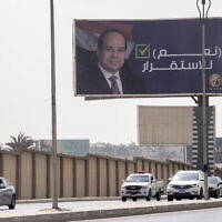 Vehicles pass under a billboard supporting Egyptian President Abdel Fattah el-Sissi for the coming presidential elections, erected by Egypt's political party of Homat Watan, the Protectors of the Nation, in Cairo, Egypt, on September 4, 2023. Arabic reads, 'Yes for stability.' Egypt will hold a presidential election over three days in December, officials announced Monday, September 25, 2023. (AP Photo/Amr Nabil, File)
