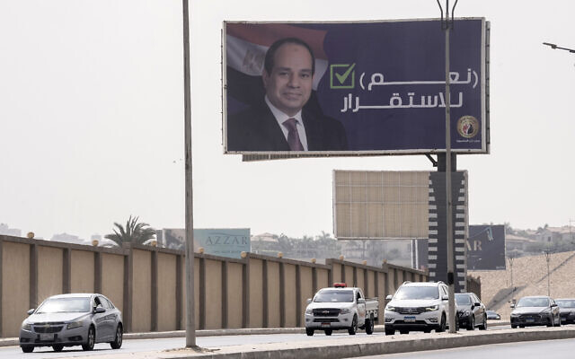 FILE - Vehicles pass under a billboard supporting Egyptian President Abdel Fattah el-Sissi for the coming presidential elections, erected by Egypt's political party of Homat Watan, the Protectors of the Nation, in Cairo, Egypt, on Sept. 4, 2023. Arabic reads, "Yes for stability." Egypt will hold a presidential election over three days in December, officials announced Monday, Sept. 25, 2023. (AP Photo/Amr Nabil, File)