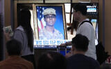 A TV screen shows a file image of American soldier Travis King during a news program at the Seoul Railway Station in Seoul, South Korea, Sept. 27, 2023. (AP Photo/Ahn Young-joon)