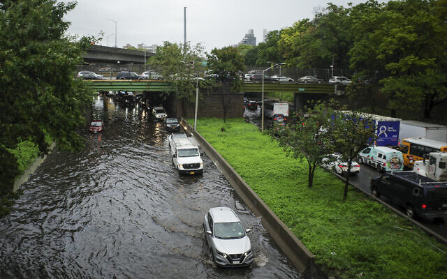 Traffic makes its way through flood waters along the Brooklyn Queens Expressway, September 29, 2023, in New York. (AP Photo/Robert Bumsted)