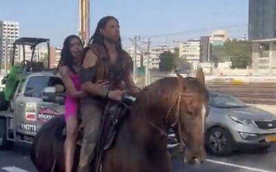 Screen capture from video of Michal Weizman, left, and Roy Oz, riding a horse along the Ayalon Highway in Tel Aviv, September 6, 2023. (X. Used in accordance with Clause 27a of the Copyright Law)
