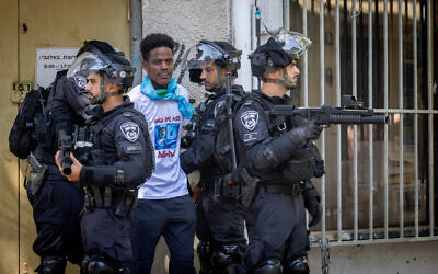 File: An Eritrean asylum seeker being detained by police amid clashes between protesters against the regime in Asmara and pro-regime activists in south Tel Aviv, September 2, 2023. (Yonatan Sindel/Flash90)
