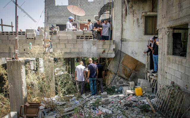 Palestinians inspect a damaged house after an Israeli military raid in the West Bank city of Jenin, September 4, 2023. (Nasser Ishtayeh/Flash90)