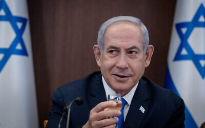 Prime Minister Benjamin Netanyahu raises a toast at the weekly cabinet meeting ahead of the Jewish New Year,  September 10, 2023. (Chaim Goldberg/Flash90)