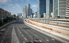 People ride their bicycles along the empty Ayalon highway in Tel Aviv, on  Yom Kippur, the Day of Atonement, September 25, 2023. (Miriam Alster/Flash 90)