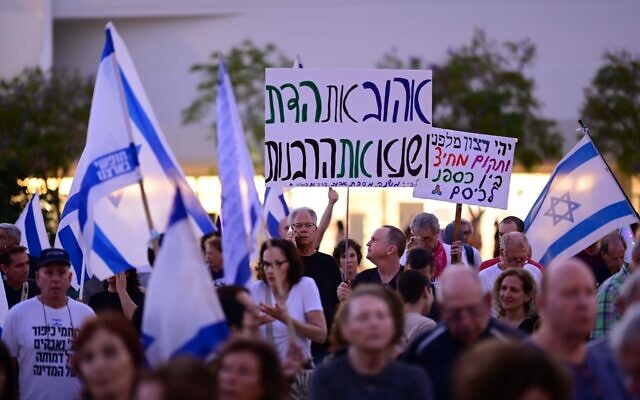 Israelis attend a rally at Habima Square in Tel Aviv, September 28, 2023. The larger sig reads: "love religion, hate the Rabbinate." (Tomer Neuberg/Flash90)