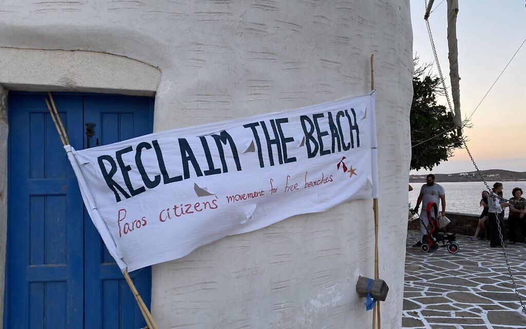 Citizens of Paros, Greece, feel deprived of their beach amid the explosion of beach privatization, and often make signs such as the one pictured here in August 2023. (Romain Chauvet)