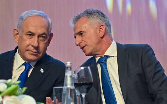 Prime Minister Benjamin Netanyahu (L) speaks to Mossad chief David Barnea at Mossad headquarters during a New Year toast on September 14, 2023. (Kobi Gideon/GPO)