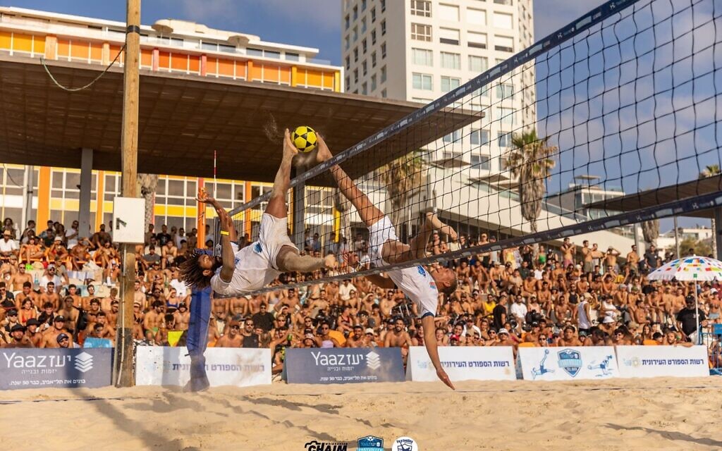 Sergio Leandro, left, and Pablos Santos simultaneously perform the Shark Attack and Shark Block, July 29, 2023, at Frishman Beach in Tel Aviv. (Chaim Weingarten)