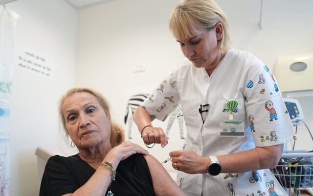 A woman gets her flu vaccine shot on September 5, 2023. (Clalit)