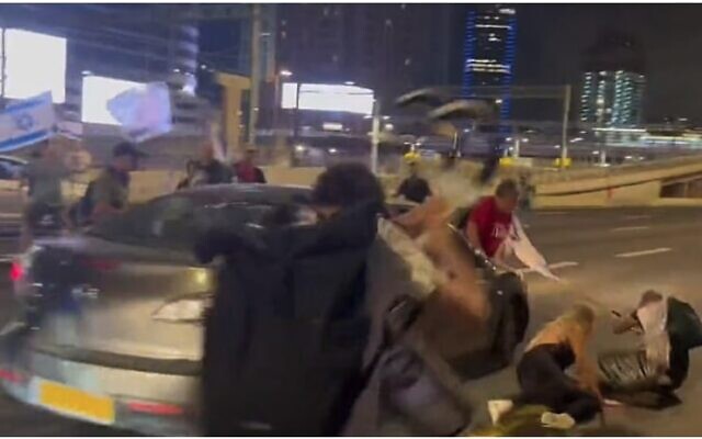 A car plows into anti-overhaul protesters on Tel Aviv's Ayalon highway on September 9, 2023. (Screen capture/Twitter)