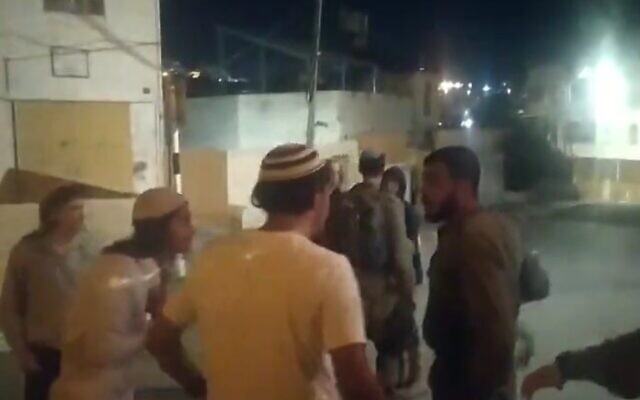 IDF soldiers try and separate brawling Israeli and Palestinian youths in the West Bank city of Hebron on September 16, 20233 (Screencapture/X)