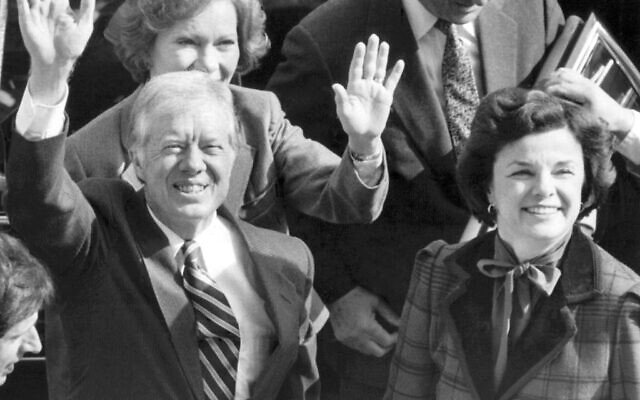 Former US President Jimmy Carter and his wife, Rosalynn, back left, wave to photographers on the City Hall balcony as they arrive with San Francisco Mayor Dianne Feinstein, right, in San Francisco, February 1, 1983. (AP Photo/Eric Risberg, File)