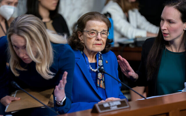 US Sen. Dianne Feinstein is flanked by aides as she returns to the Senate Judiciary Committee following a more than two-month absence as she was being treated for a case of shingles, at the Capitol in Washington, May 11, 2023. (AP Photo/J. Scott Applewhite, File)
