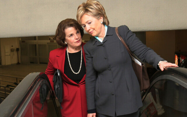 Sen. Hillary Rodham Clinton, right, talks with Sen. Dianne Feinstein on their way to vote on the Deficit Reduction Act on Capitol Hill in Washington, December 21, 2005. (AP Photo/Lauren Victoria Burke, File)