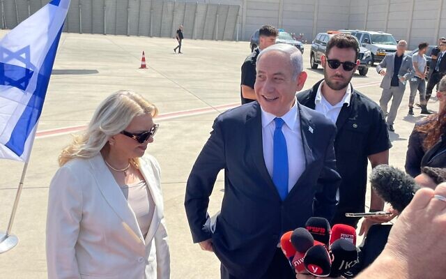 Prime Minister Benjamin Netanyahu and his wife Sara speak to the press from the tarmac at Ben Gurion International Airport on September 3, 2023. (Carrie-Keller-Lynn/Times of Israel)