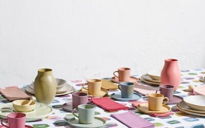 Stylist Nurit Kariv sets this table with pieces from Nu, her home brand collection that includes a tablecloth designed with her own watercolors (Courtesy Nu)