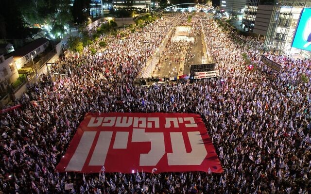 A photo provided by an anti-judicial overhaul activist shows thousands protesting in Tel Aviv with a sign reading 'The court is supreme,' September 9, 2023. (Gilad Furst)