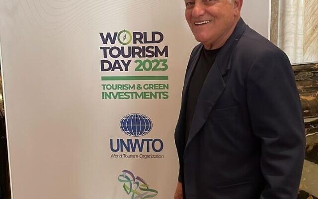 Tourism Minister Haim Katz poses next to a UNWTO poster in Riyadh, Saudi Arabia on September 26, 2023 (Courtesy Haim Kaitz)